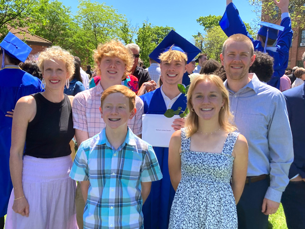 featured alum with family at high school graduation